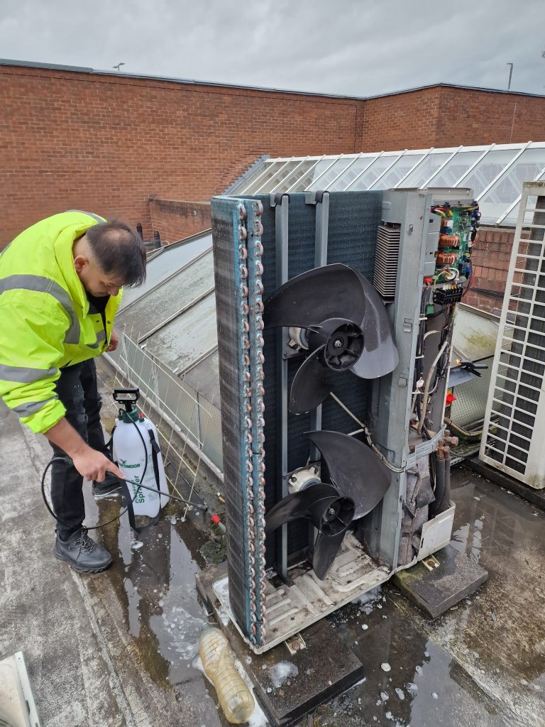 Engineer working on an outdoor air conditioning unit